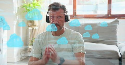 Mature man meditating with headphones and smartwatch in sunlit lounge with cloud overlay