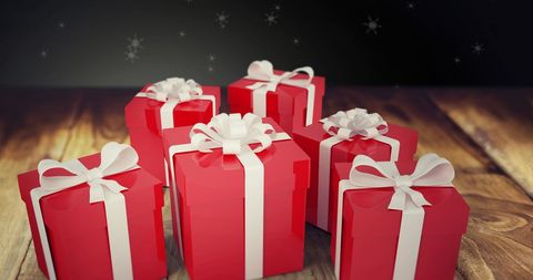Festive Christmas Gifts Surrounded by Falling Snowflakes - Download Free Stock Images Pikwizard.com