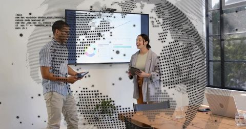 Team presenting business dashboard with tablets and dotted globe overlay modern boardroom