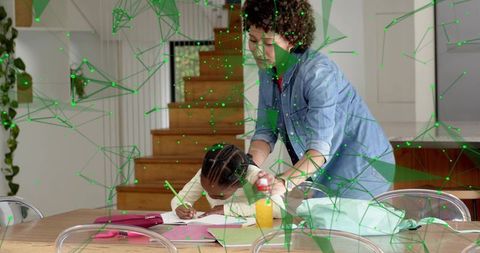 Caregiver helping child with homework at kitchen table with green digital network overlay
