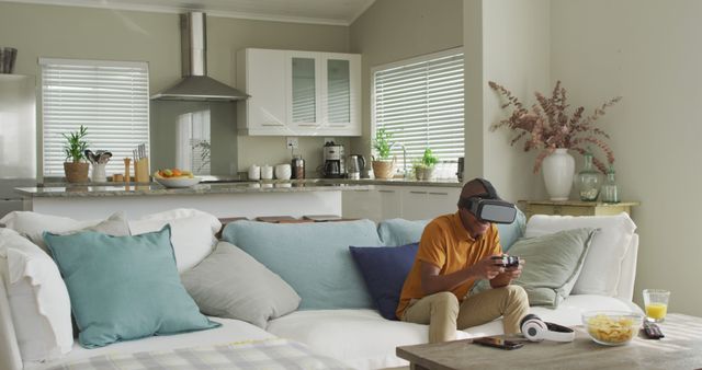 Image of happy african american boy using vr headset and playing image games at home. Childhood, spending time with technology at home concept.