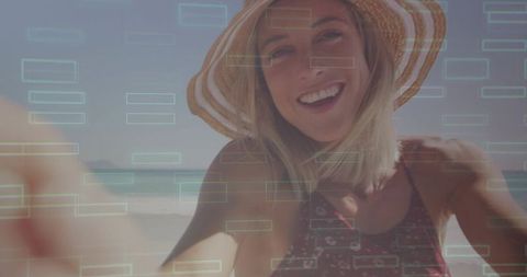 Smiling woman reaching forward on sunny beach with digital hud overlay