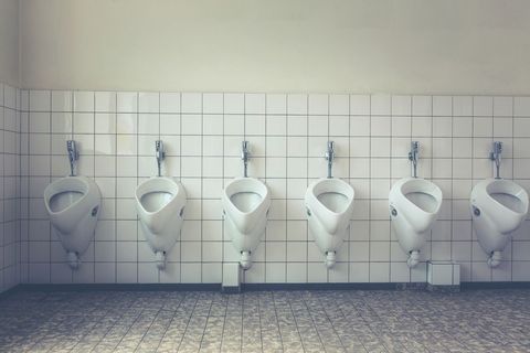 Empty row of urinals in clean public restroom