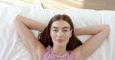 Relaxed Teen Girl Lying on Bed with Hands Behind Head - Download Free Stock Images Pikwizard.com