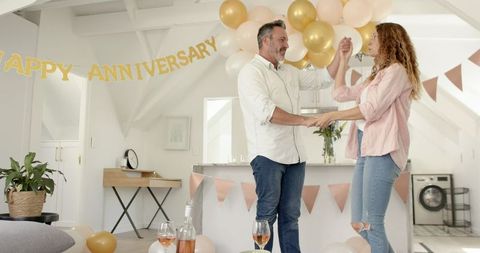Mature Couple Joyfully Dancing at Anniversary Celebration Party