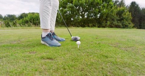 Senior woman ready to tee off on golf course
