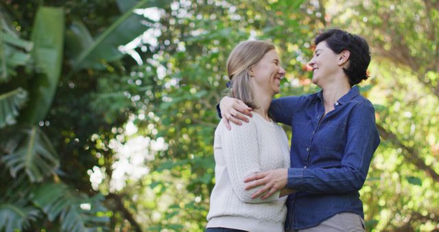 Caucasian lesbian couple hugging and embracing each other in the garden - Download Free Stock Photos Pikwizard.com