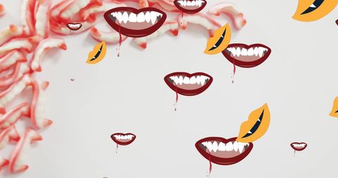 Halloween Vampire Teeth with Sweets on Grey Background