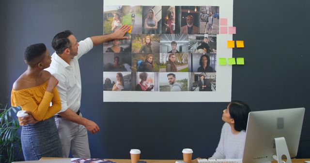 Professional Team Analyzing Photographs on Office Wall - Download Free Stock Images Pikwizard.com