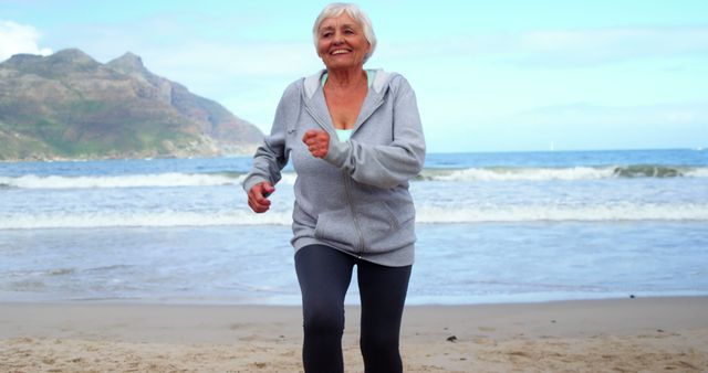 Senior Woman Exercising on Beach in Morning - Download Free Stock Images Pikwizard.com