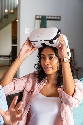 Woman Using VR Headset in Modern Living Room Setting