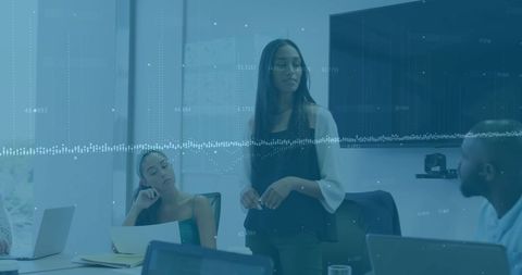 Diverse team engaged in digital meeting inside modern workspace