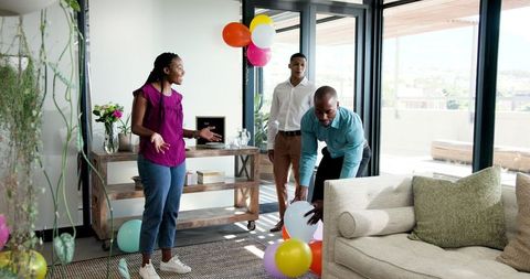 Colleagues Preparing Office for Joyful Celebration with Balloons