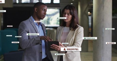 Business Colleagues Collaborating on Tablet in Modern Office Setting