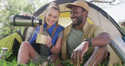 Happy Couple Camping and Enjoying Tea Outdoors