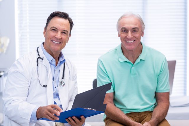Portrait of smiling doctor and senior patient in clinic