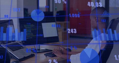 Man Engaged at Work Desk with Data Analytics Display