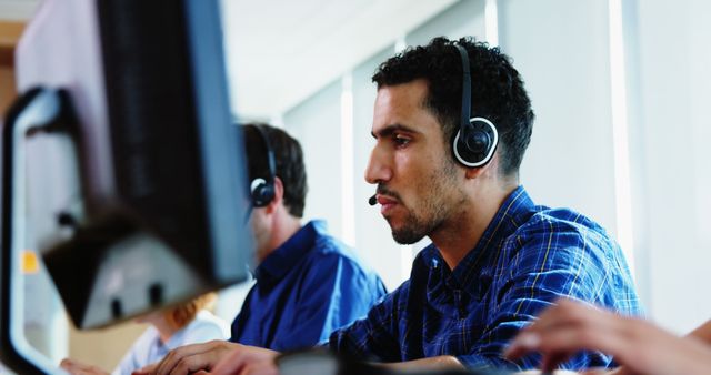 Focused Customer Service Representatives Wearing Headsets Working at Desks - Download Free Stock Images Pikwizard.com