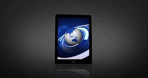 Tablet displaying blue globe and futuristic network interface on reflective surface
