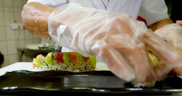 Chef Preparing Fresh Sushi Rolls in Kitchen with Gloves - Download Free Stock Images Pikwizard.com