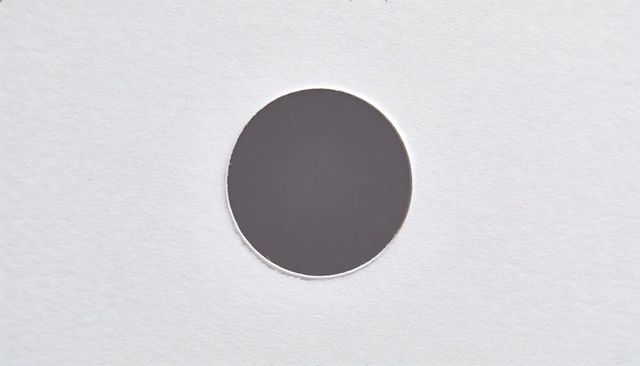 White Textured Cardstock Showing Clean Circular Punch Revealing Dark Backing