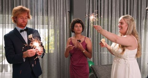 Wedding celebration with sparklers indoors joyous friends moment