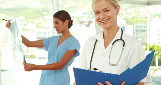 Smiling Physicians in Modern Medical Clinic Evaluating Patient Records - Download Free Stock Images Pikwizard.com