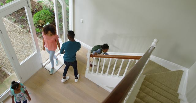 Family Enters New Home with Kids Climbing Staircase - Download Free Stock Images Pikwizard.com