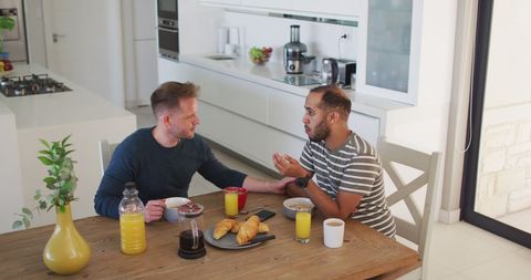 Multiracial Same-Sex Couple Conversing Over Breakfast - Download Free Stock Images Pikwizard.com