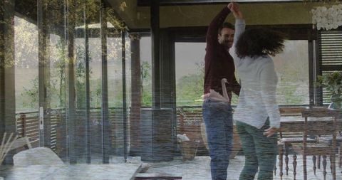Couple joyfully dancing in elegant contemporary living room