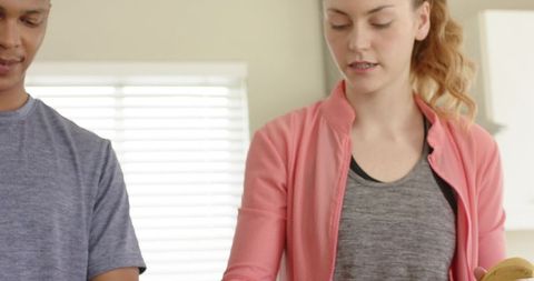 Couple preparing fresh banana breakfast together in bright home kitchen counter daylight