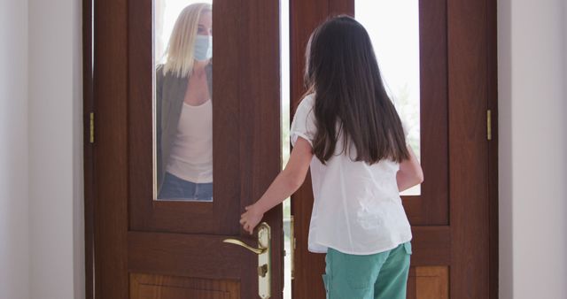 Child Opening Front Door to Visitor Wearing Face Mask - Download Free Stock Images Pikwizard.com