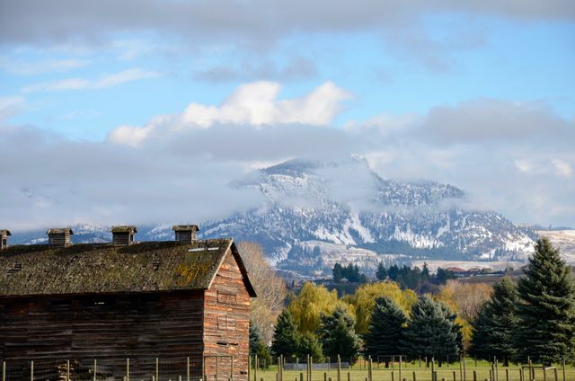 Scenic Rural Landscape with Snow-Capped Mountains and Rustic Farmhouse - Download Free Stock Photos Pikwizard.com