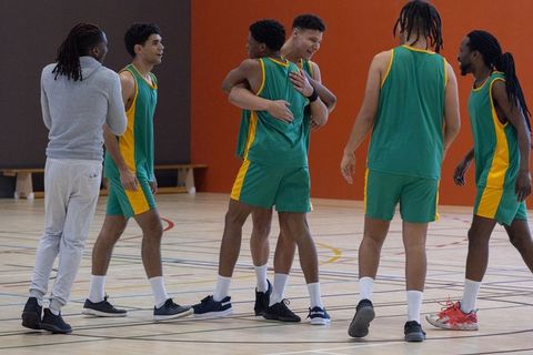 Basketball team celebrating victory with camaraderie and joy