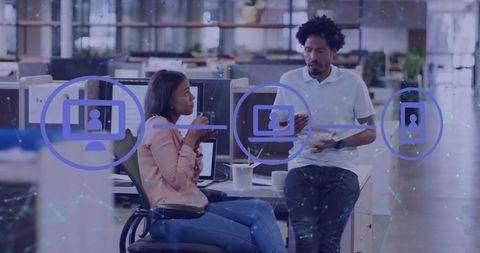 Diverse team engaging in digital interaction in modern office