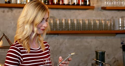 Woman Using Phone with Wine Glass at Stylish Bar - Download Free Stock Images Pikwizard.com