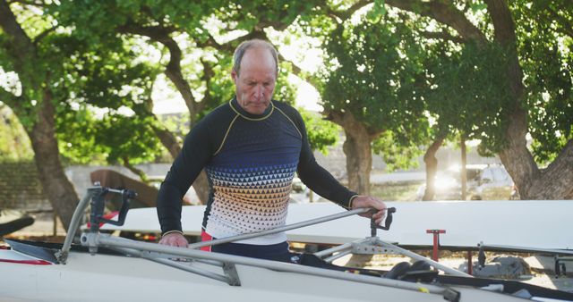 Man Preparing Rowing Boat Under Trees for Outdoor Activity - Download Free Stock Images Pikwizard.com