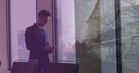 Asian Businessman Using Smartphone with Global Data Overlay