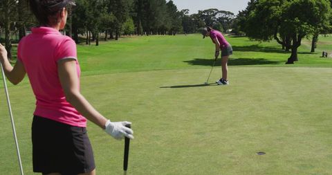 Women Engaging in Competitive Golfing on Lush Green Course - Download Free Stock Images Pikwizard.com