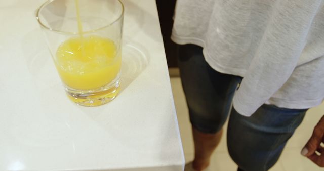 Pouring Orange Juice into Clear Glass in Kitchen - Download Free Stock Images Pikwizard.com