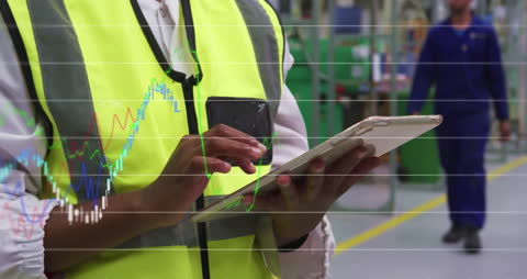 Depicting professional women in a workplace interacting with technology, ideal for illustrating concepts related to business analysis, stock market data, or workplace innovation. Useful for resources discussing the integration of technology in business operations, financial analysis, or digital workflow in modern industries.