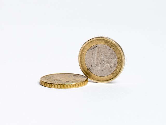 Two 1 euro cent coins against white background. Finance, economy and currency concept