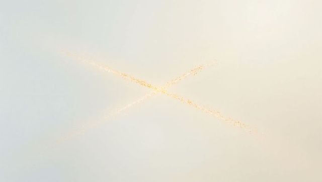 Golden x-shaped particle streaks glowing on soft blue to warm beige gradient background