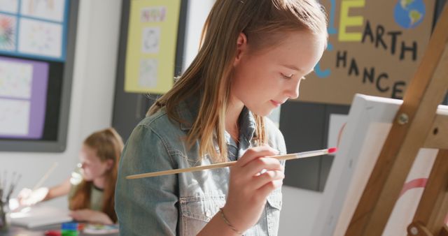 Young Girl Painting on Easel in Classroom - Download Free Stock Images Pikwizard.com