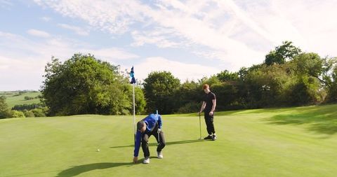 Father and Son Enjoying a Peaceful Golf Game Outdoors