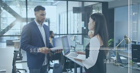 Diverse Professionals Utilizing Technology in Modern Office