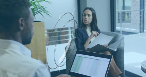 Business Professionals Analyzing Data in Open Office Space