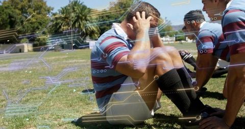 Rugby teammates supporting injured seated player during sideline first aid with futuristic ar overla