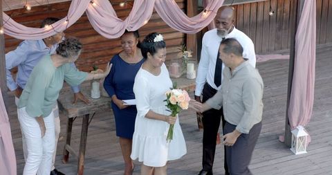 Senior Diverse Couple Celebrates Wedding Ceremony with Friends