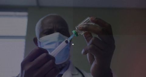 Senior Doctor Preparing Syringe in Medical Clinic